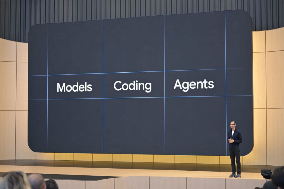 Google CEO Sundar Pichai speaks on stage Tuesday at Google I/O in front a slide that reads "models, coding, agents."