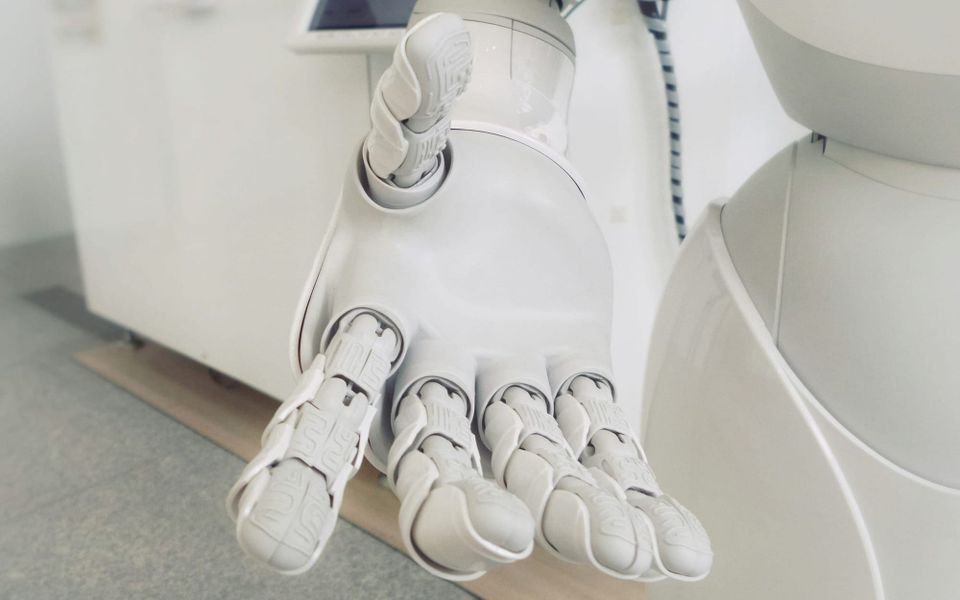 A robotic hand is held out.