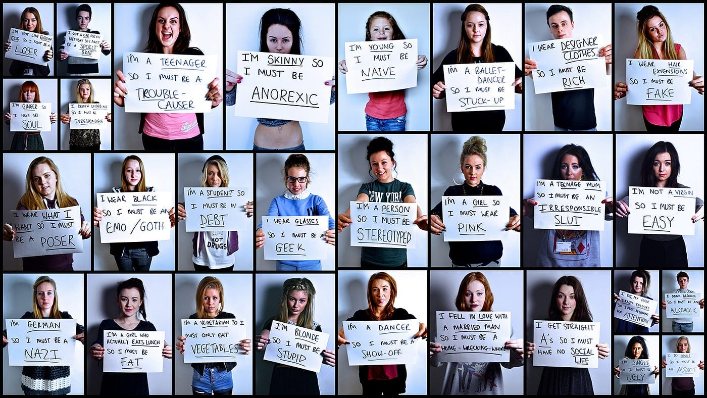 Multiple people each holding a paper with a common social bias written on it.