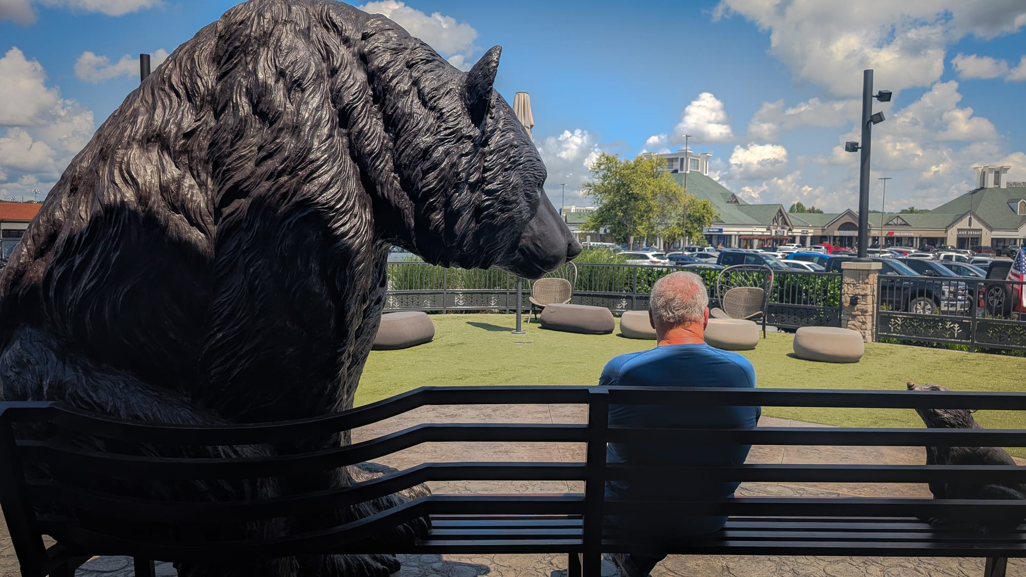 Sitting on a bench with a bear statue