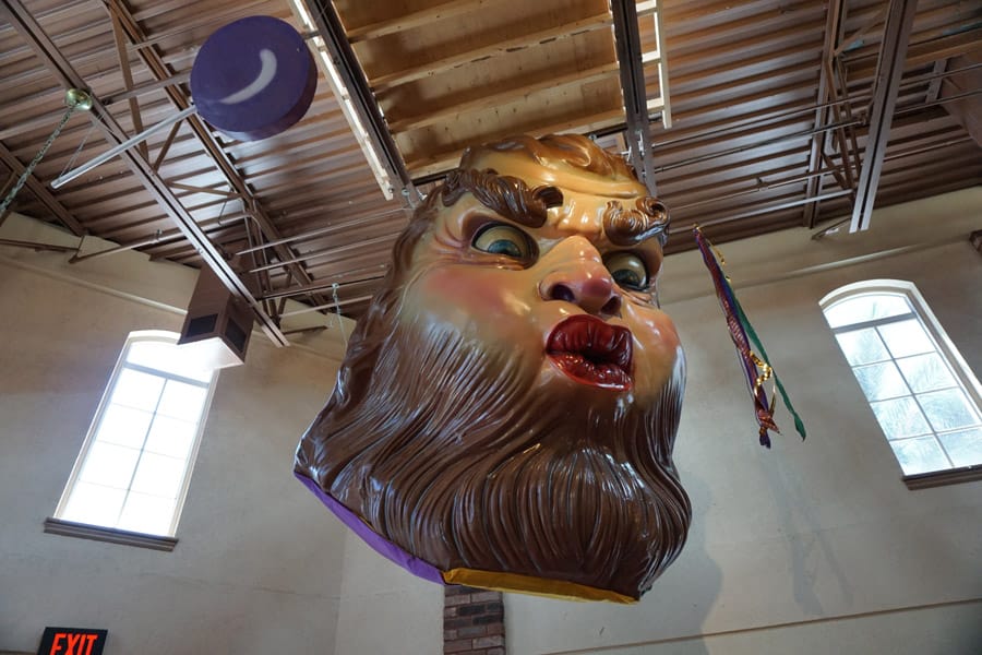 Cookies & Clogs | While traveling in the 2016 Kia Sedona, we visited the Sassagoula Floatworks and Food Factory for regular and gluten-free beignets. The massive Mardi Gras masks were creepy though.