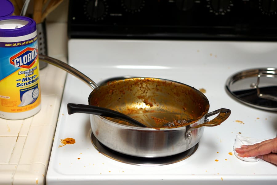 Cookies & Clogs | Parenthood makes you do and say things you never thought you'd do when raising children. See how our parenting experience has gone and what two things have helped with cleaning up their messes. Disinfecting Wipes with Micro-Scrubbers cleaning up spaghetti sauce from stove.