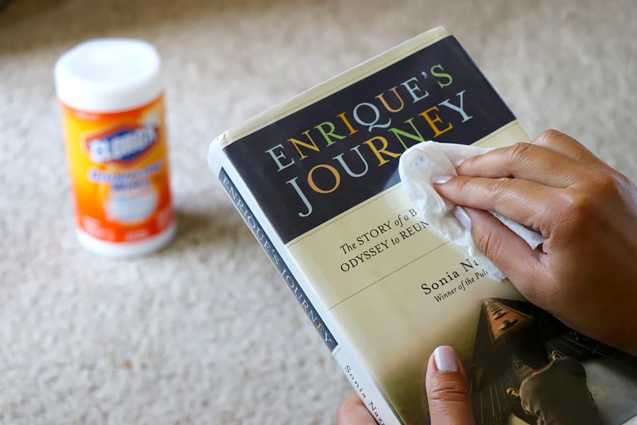 Getting ready for back to school shopping and using Clorox Disinfecting Wipes to disinfect library book covers.