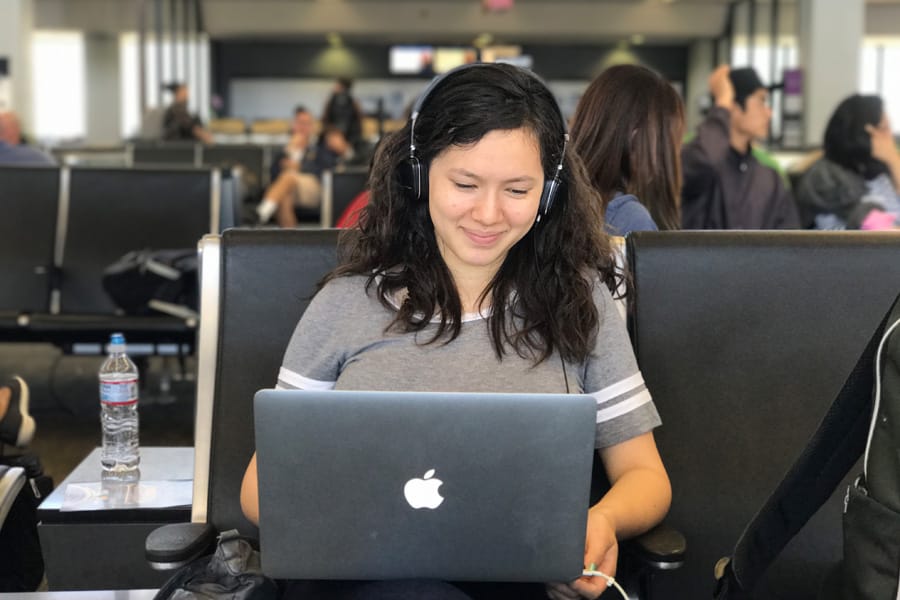 Pass airport security screening in 5 minutes | Teen girl on laptop at airport