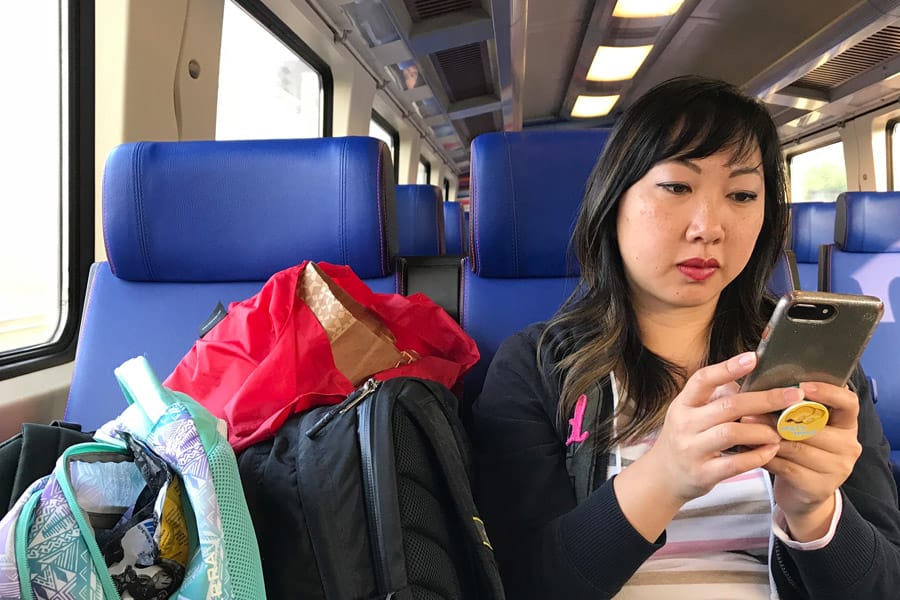 Reasonable and Reliable Cell Phone Service in Europe and other countries with Verizon TravelPass - Woman on phone on Train from Amsterdam, Holland