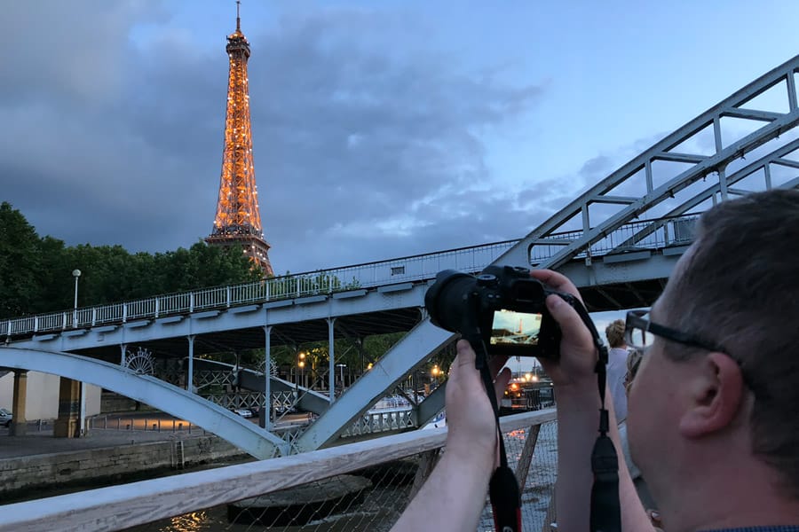 Best Paris boat tour tips for sightseeing cruise on the Seine River in Paris, France. Taking photo of Eiffel Tower