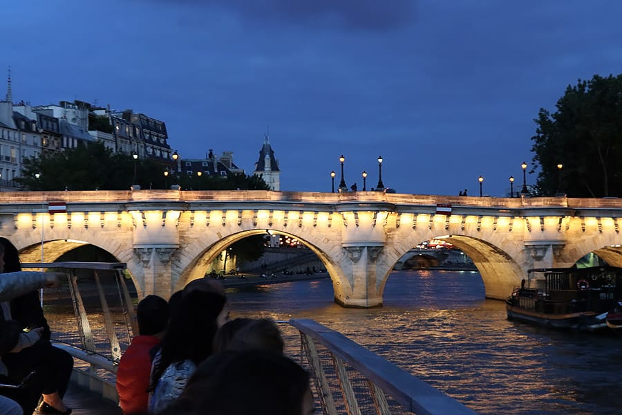 Best Paris boat tour tips for sightseeing cruise on the seine in Paris, France. Bridge at night
