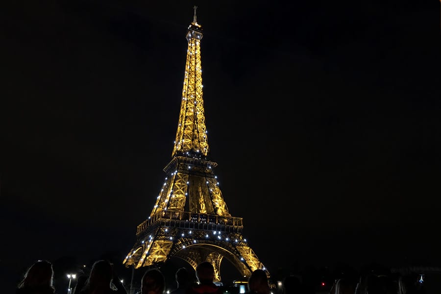 Best Paris boat tour tips for sightseeing cruise on the seine in Paris, France. Eiffel Tower at night sparkling