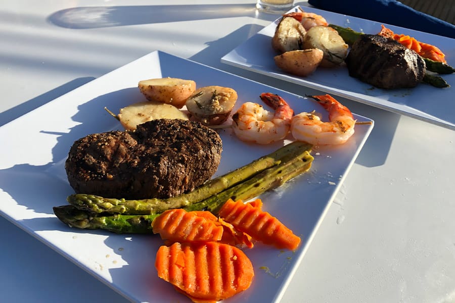 Top things to do in Kauai Hawaii — Kauai Napali Coast boat tour / Na Pali Coast sunset cruise gluten free filet mignon and shrimp