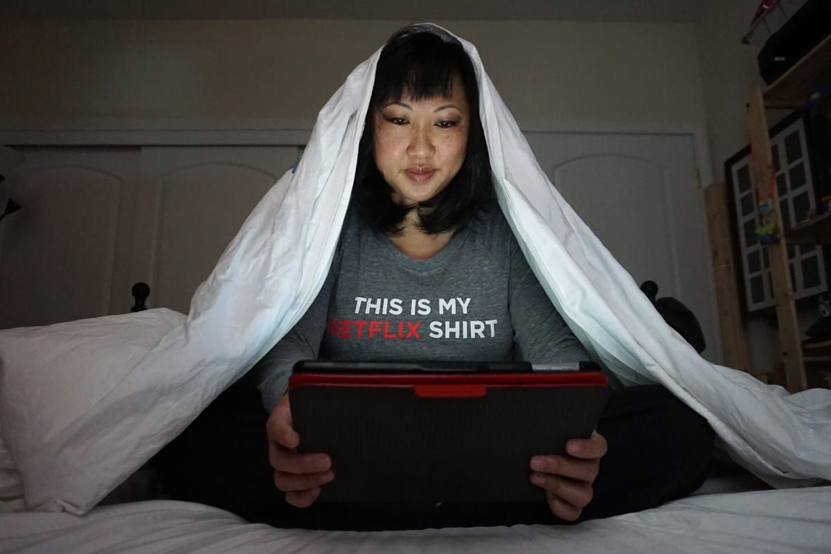 Cookies &amp; Clogs | Multimedia | Mom doing the Netflix Sneak under the covers.