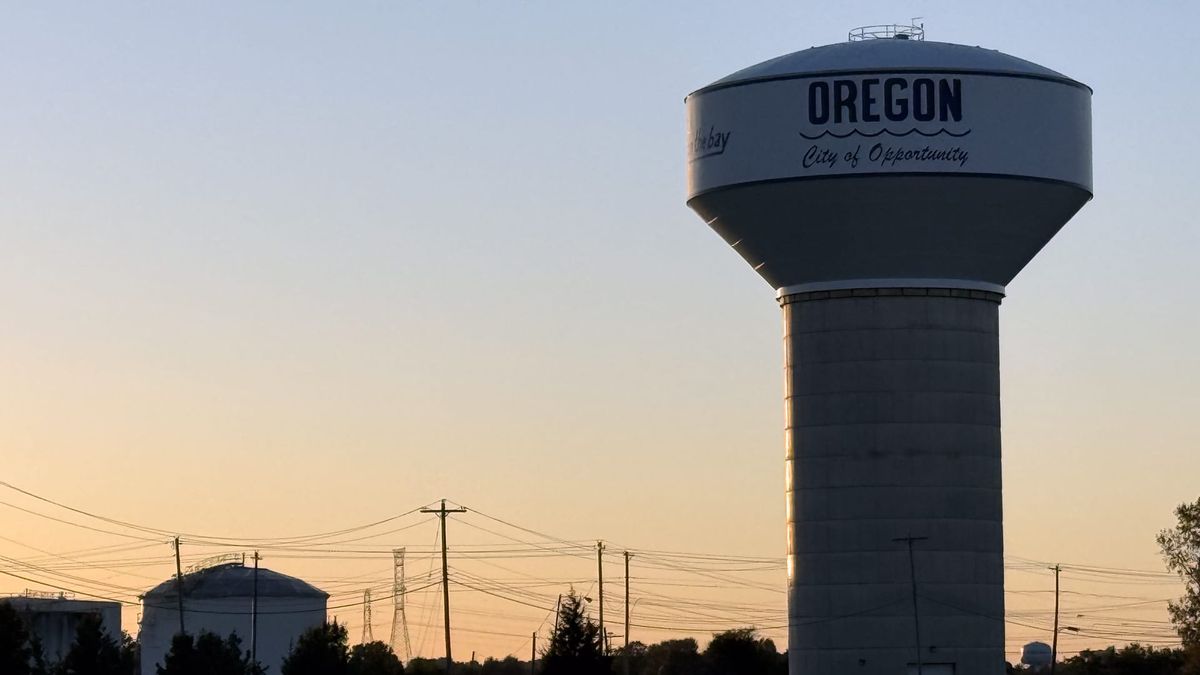 Oregon, Ohio water tower displaying “City of Opportunity” at sunset.
