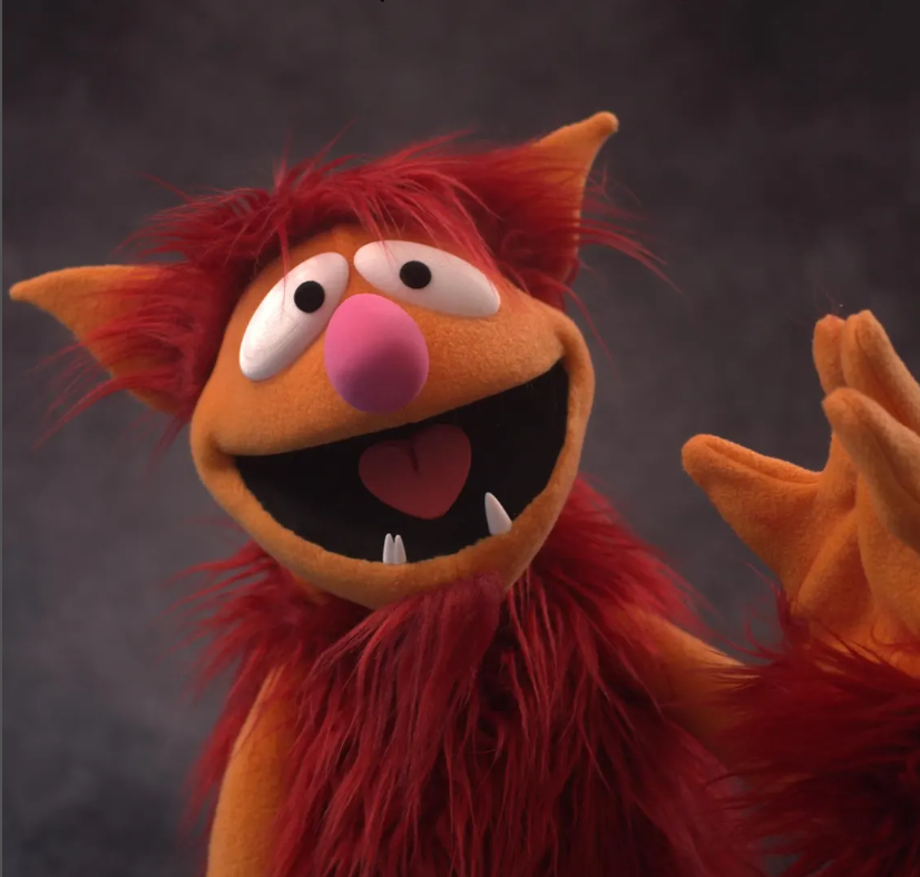 A cheerful puppet character waving hello