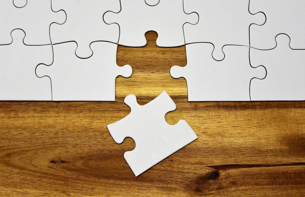 A jigsaw with one puzzle piece missing. 