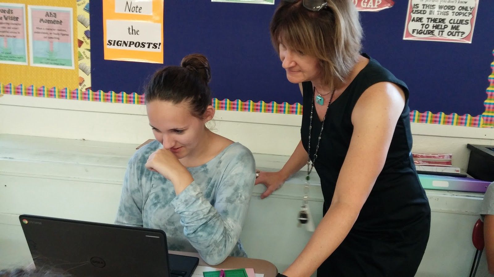 Guest teacher Tammy Anfang with a student, both looking at a computer. 