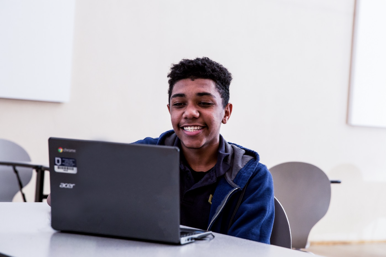A student looks at his laptop in classroom. 