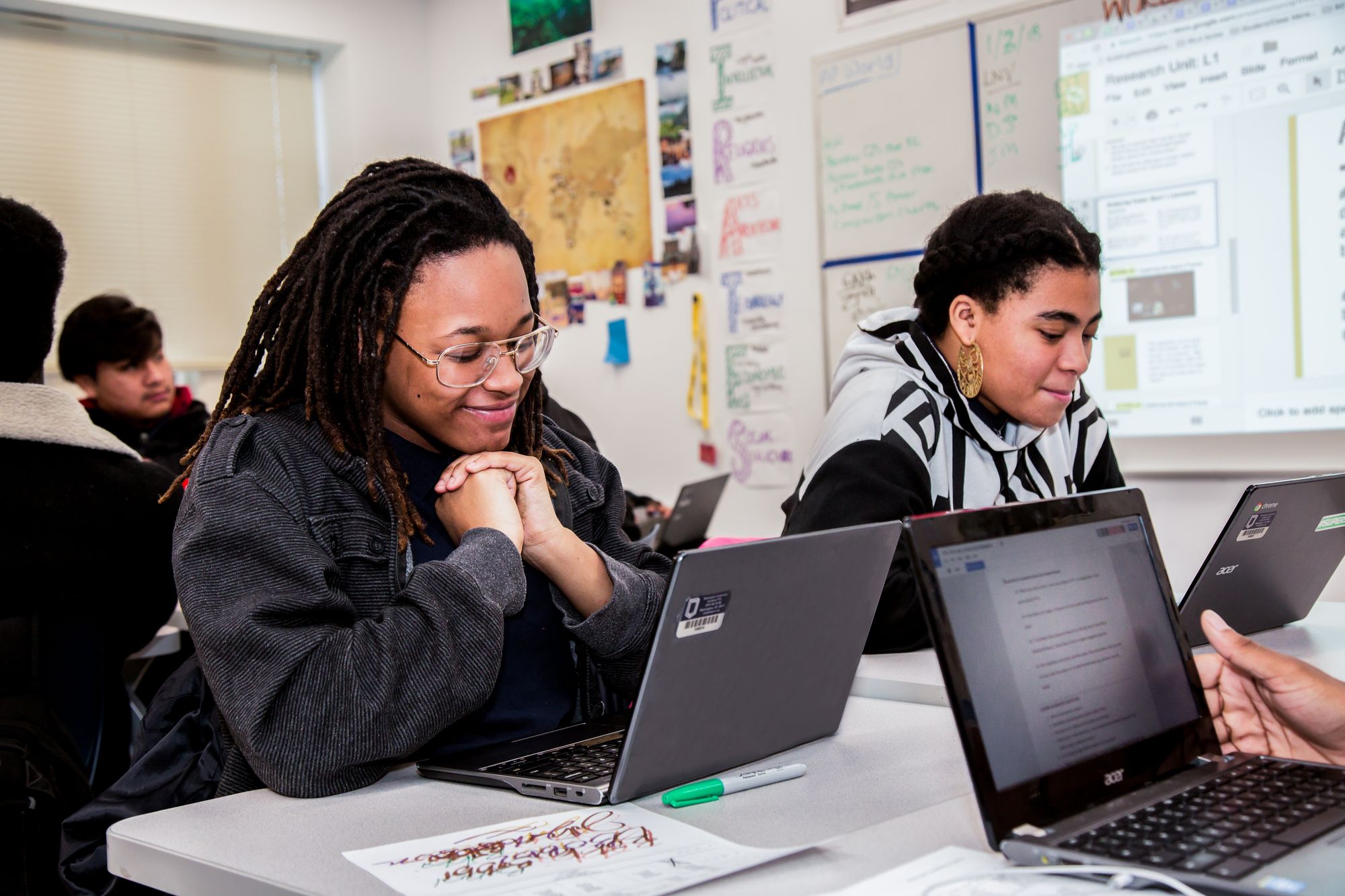 Two students read over a CommonLit lesson about friendship
