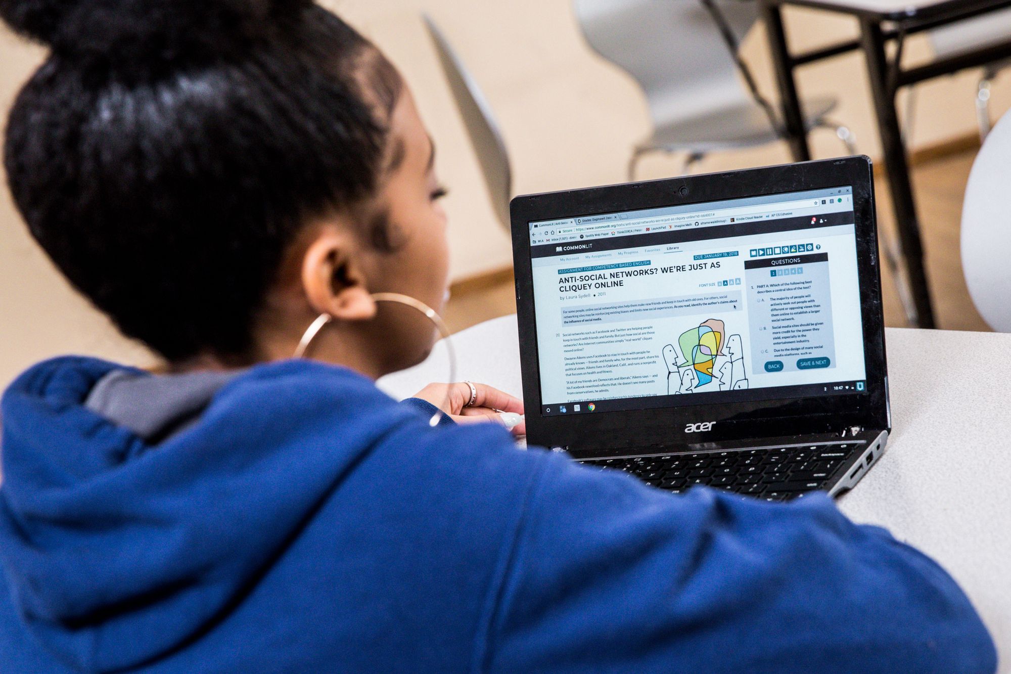 Teenage student looks at a CommonLit reading lesson on her laptop. 