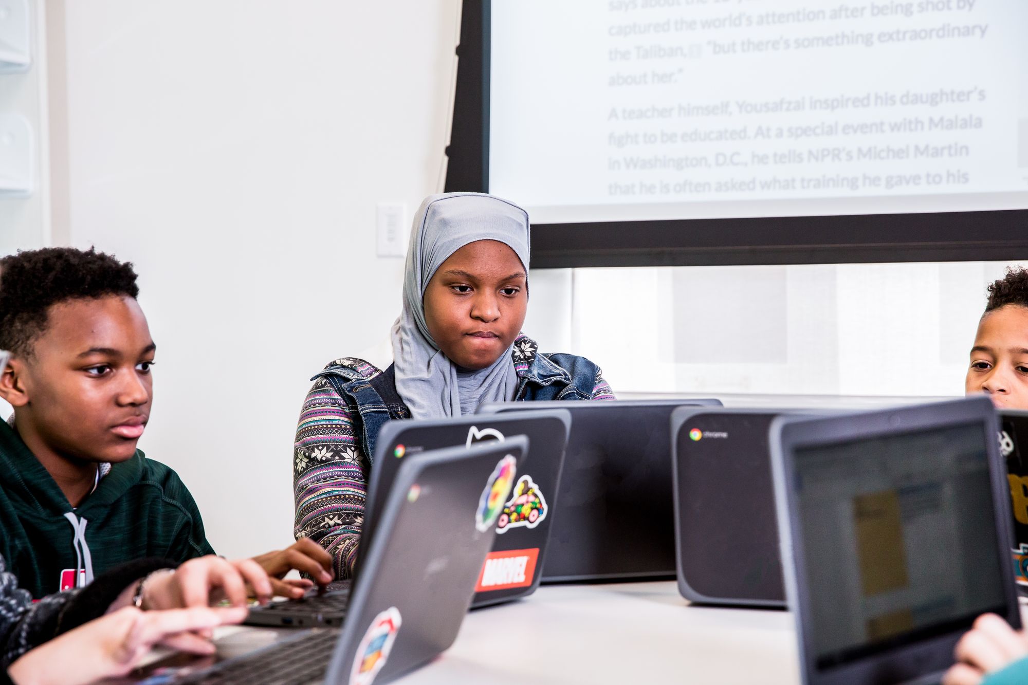 Students complete CommonLit lesson on laptops. 