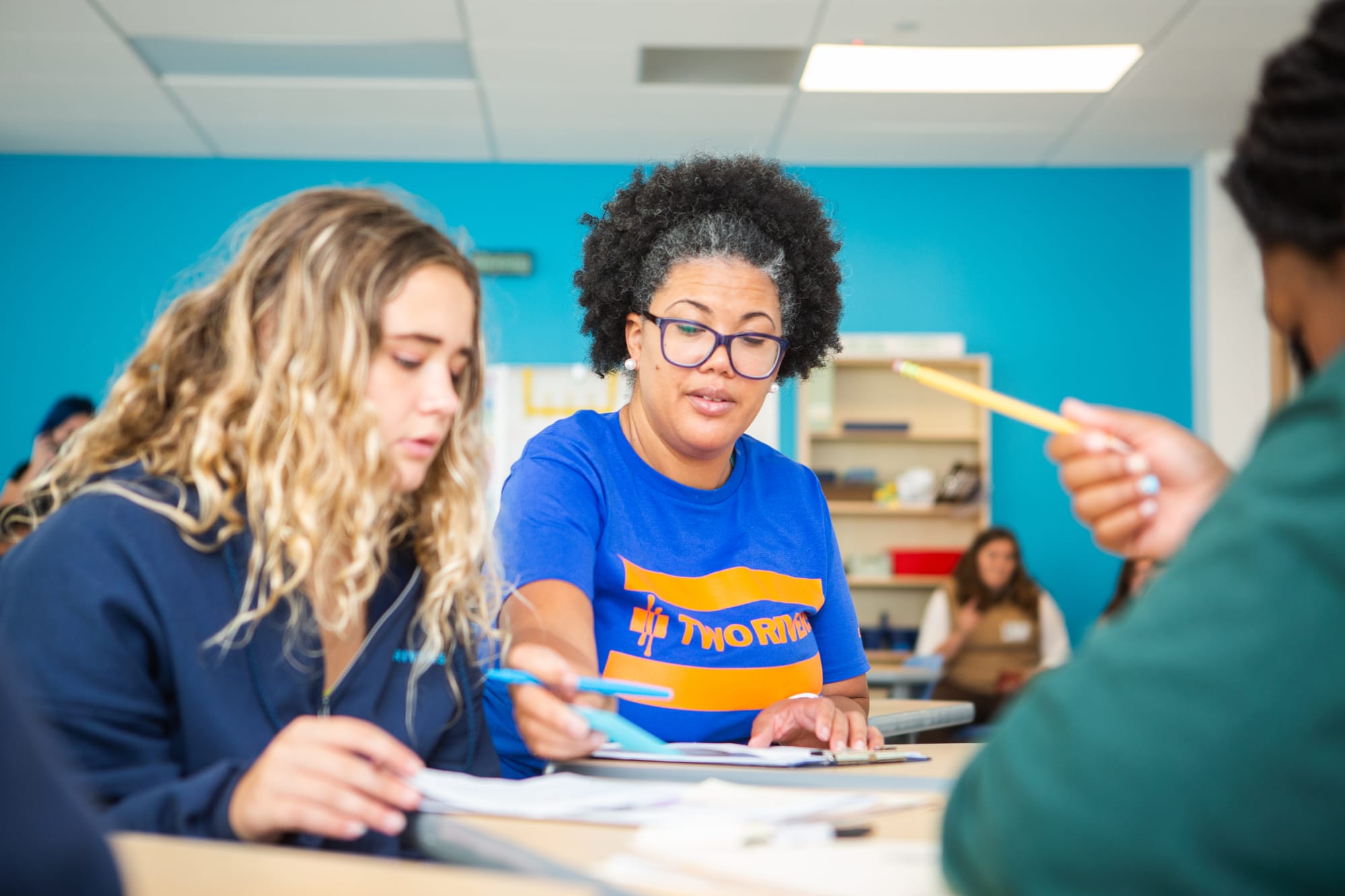 Teacher reads paper to students.