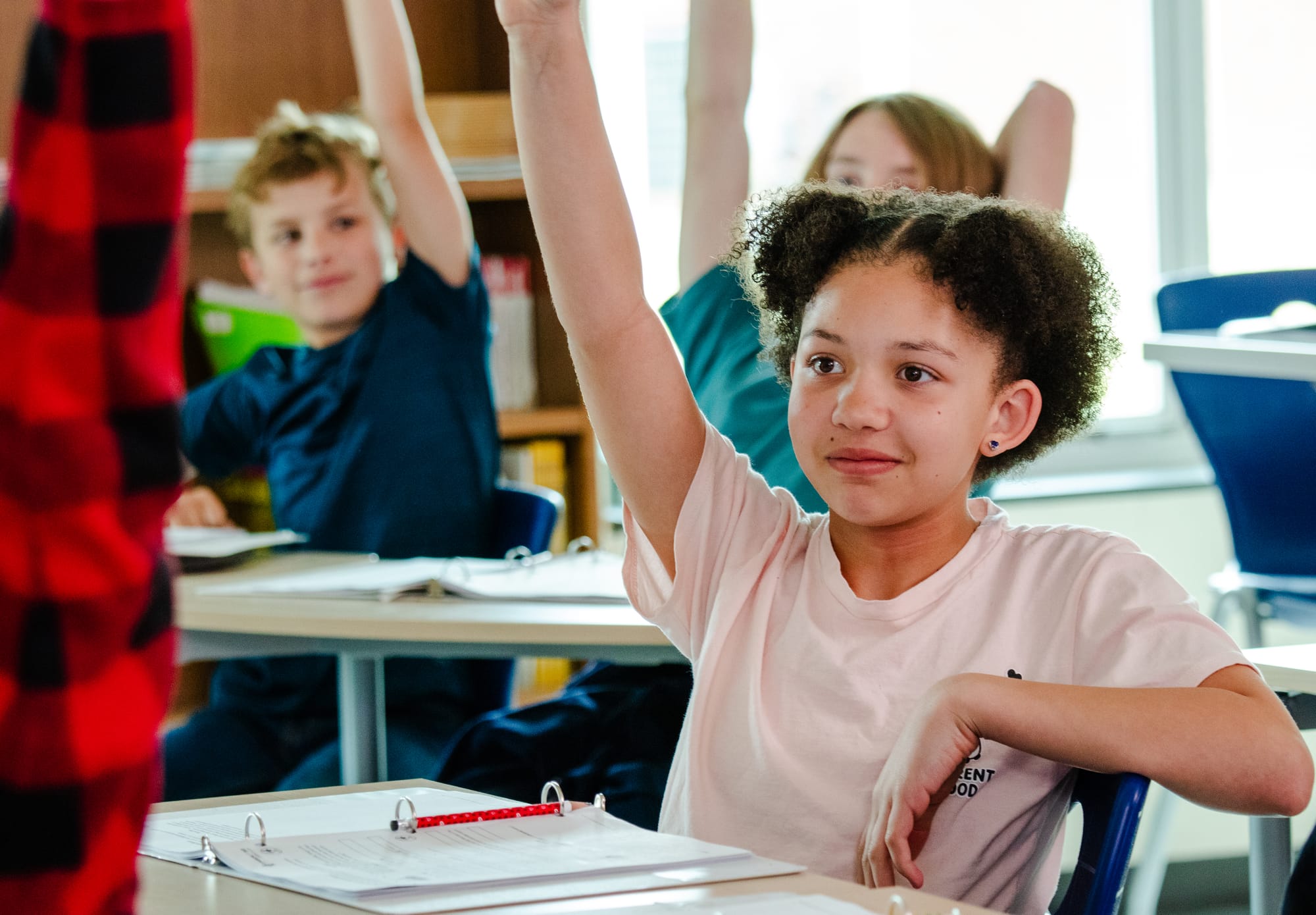 A middle school student raising her hand.
