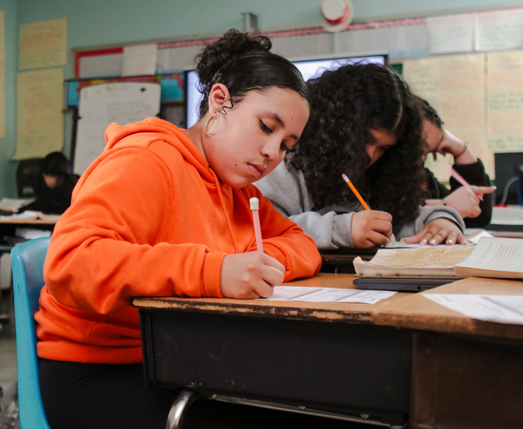 A student writing at her desk.