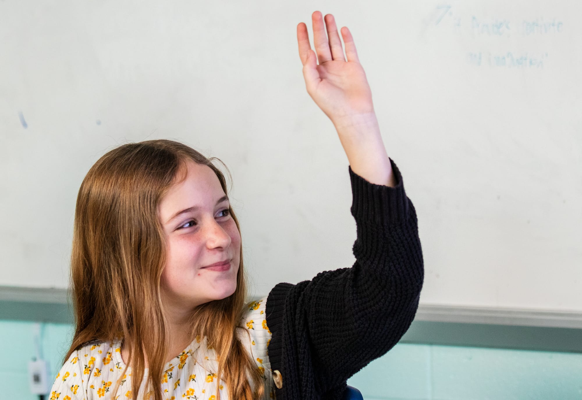 A student raising her hand.