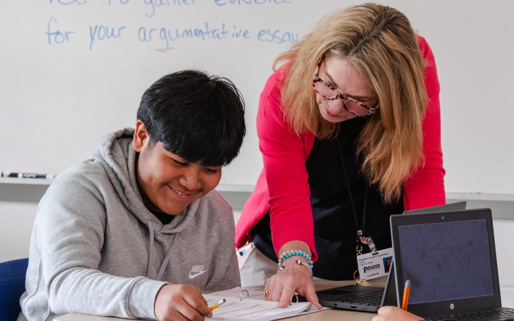 A teacher helping her student with a CommonLit 360 lesson