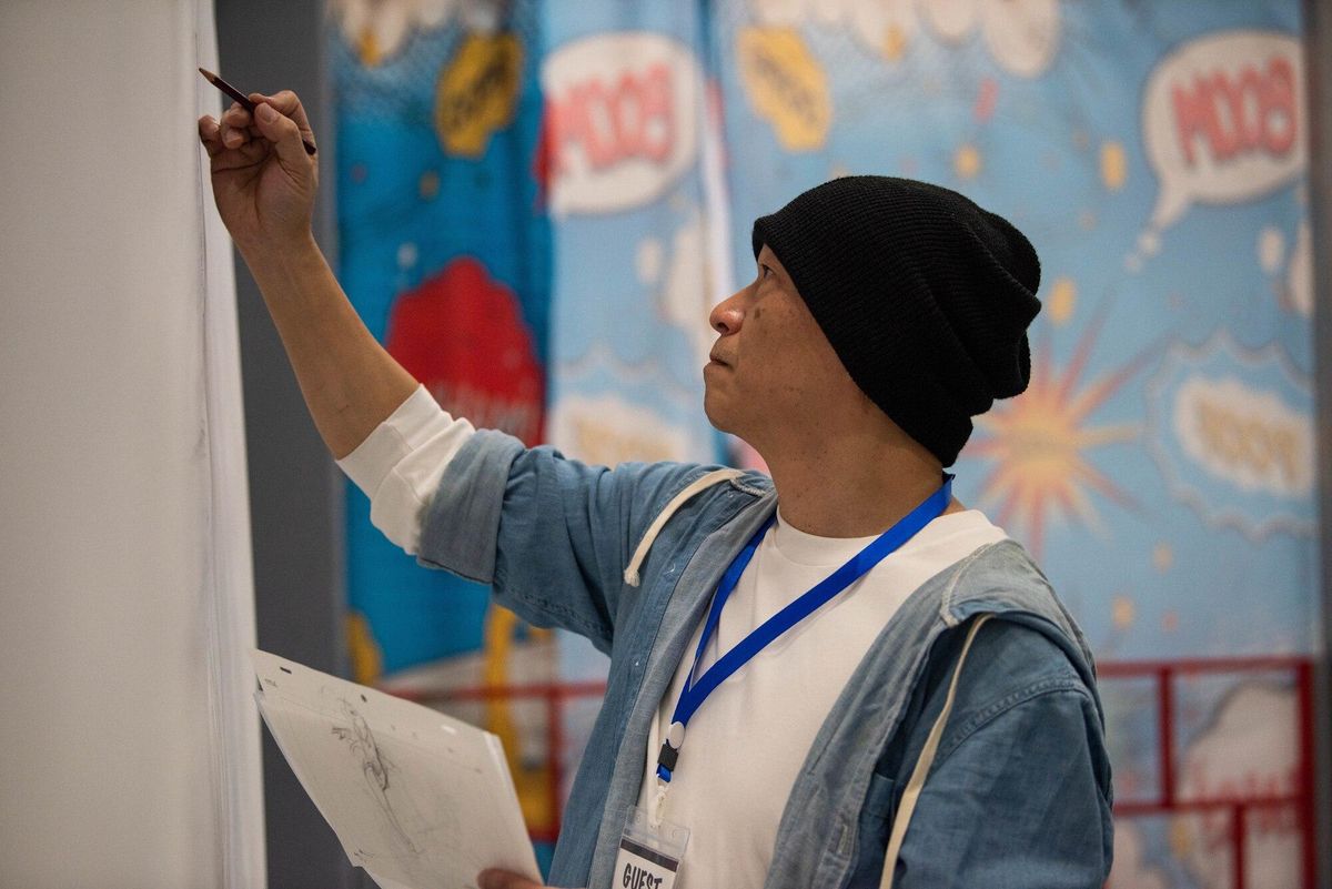 Animator Hiroshi Shimizu drawing during a live demonstration at Yokota-Con in Japan. U.S. Air Force photo by Airman 1st Class Natalie Doan