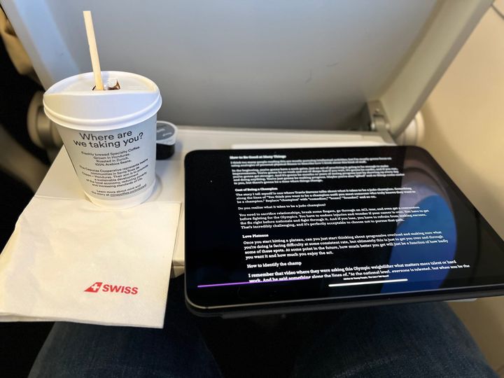 Picture of airplane tray with an iPad and a cup of terrible coffee