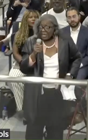 Wanda Hopkins speaks into a microphone.