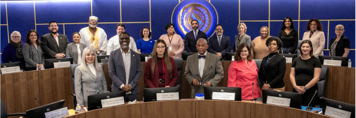 This photos includes the 21 Chicago Board of Education members of 2025, standing in the board room at CPS headquarters.