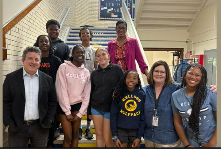 A group of people stand on a staircase at Kellogg Elementary School.