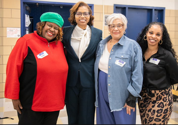 The photo shows four women standing together. CPS CEO Macquline King is second from left.