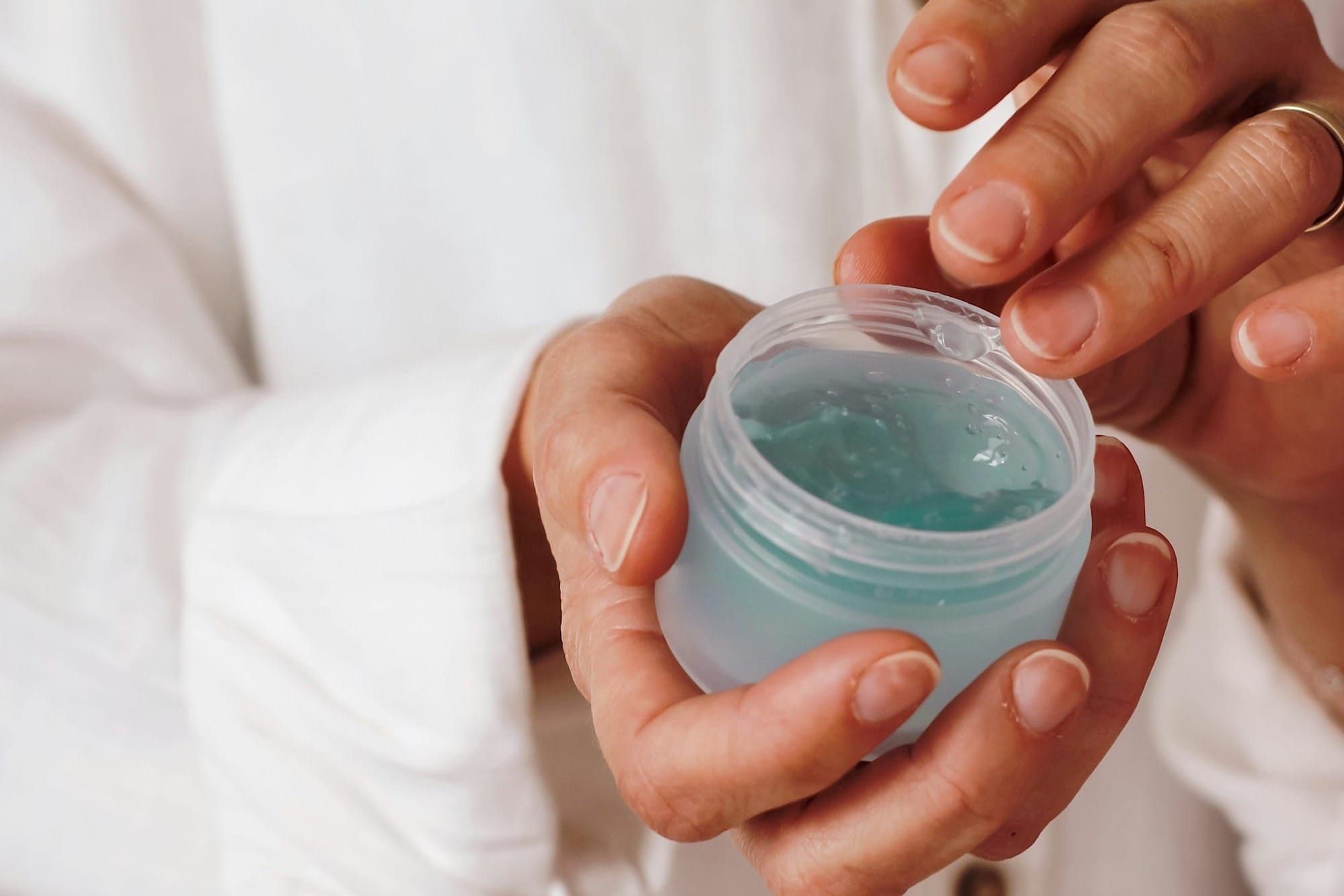 person holding blue plastic container