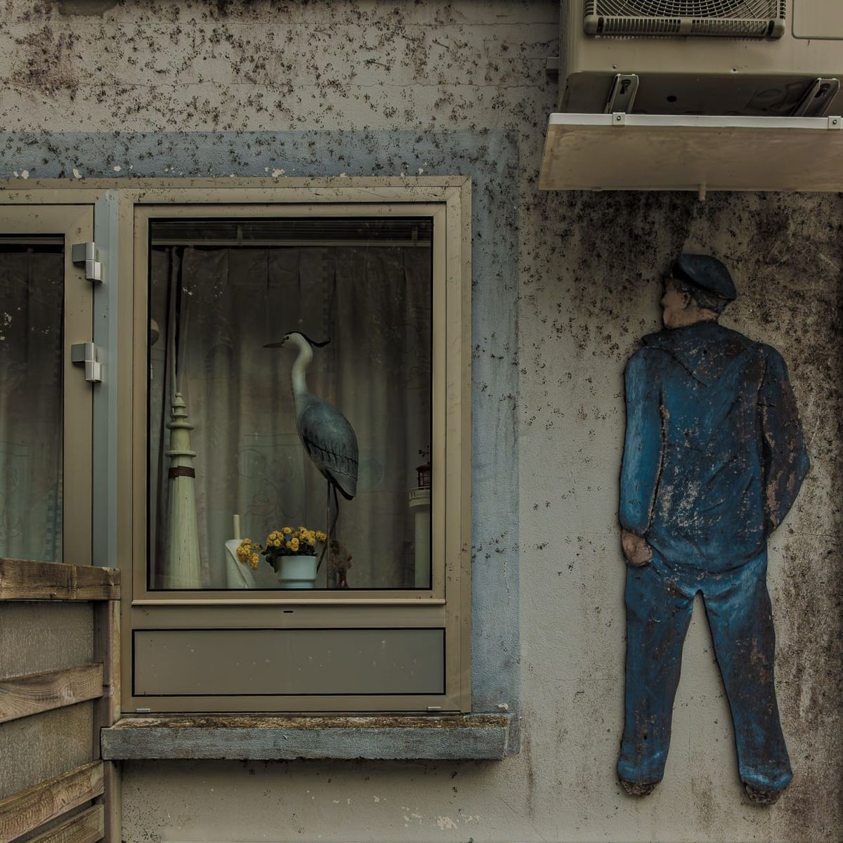 Figurine bleue face à un héron empaillé au port de Bélon, Riec-sur-Bélon, Finistère