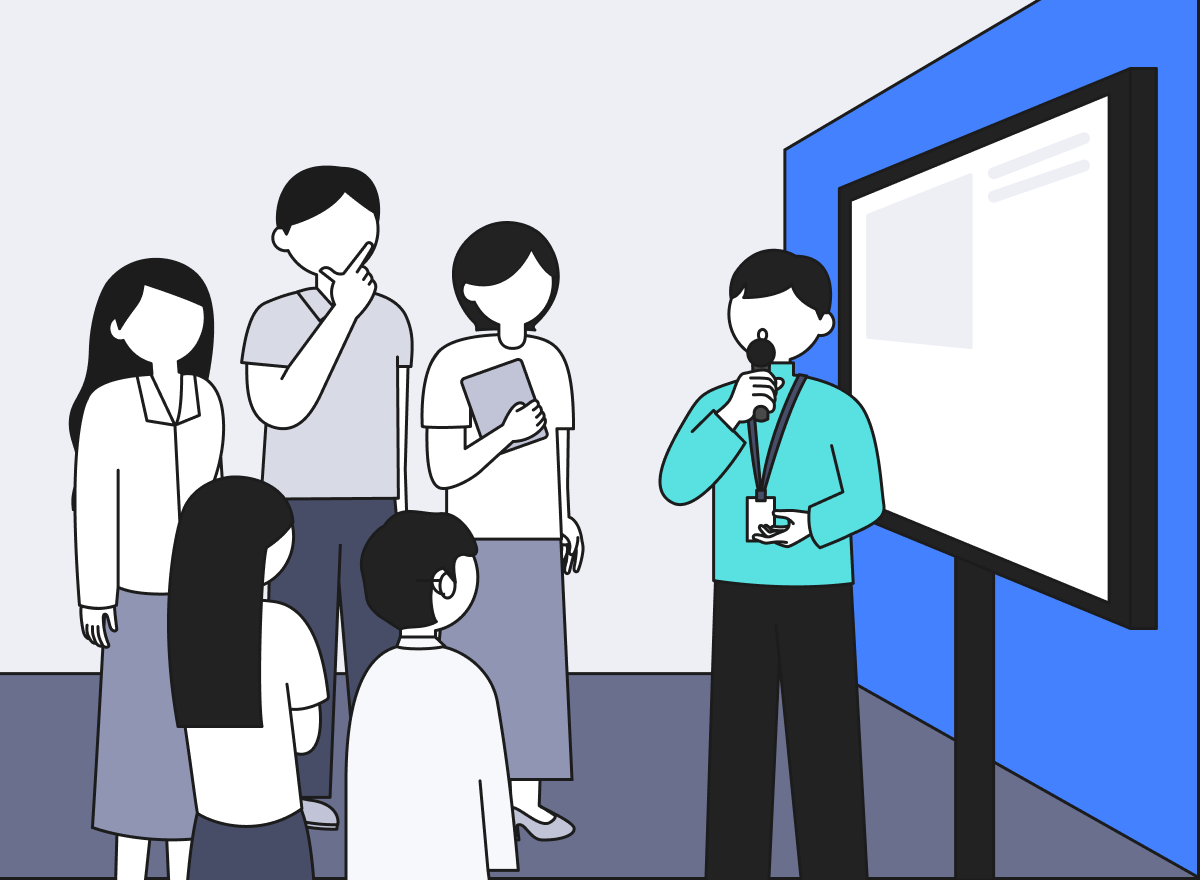 박람회 부스에서 스태프가 TV 모니터를 두고 관람객을 대상으로 제품을 설명하고 있다.