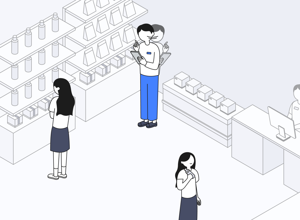 매장 직원이 매장 구석에 서서 노트를 든 채 방문객의 행동을 관찰하고 있다.