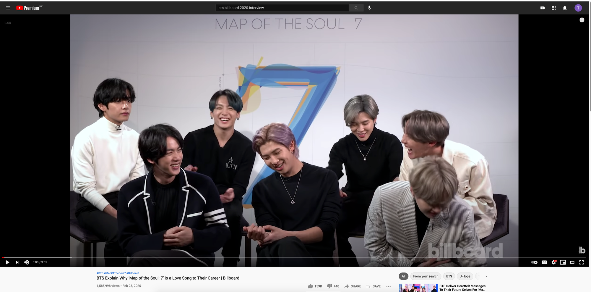 BTS's seven members sitting in front of the logo of "Map of the Soul: 7", with everyone laughing but Taehyung looking serious