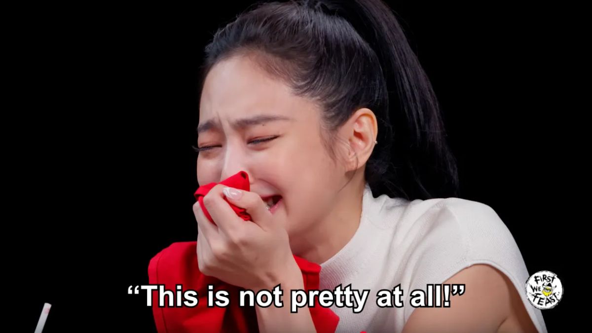 Jennie, hunched over a napkin, crying, "This is not pretty at all!" with a "First We Feast" logo