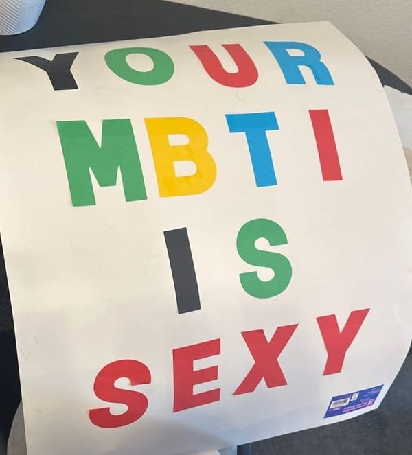 A white poster board reading "YOUR MBTI IS SEXY"