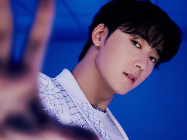 Kevin Woo framed by bright blue