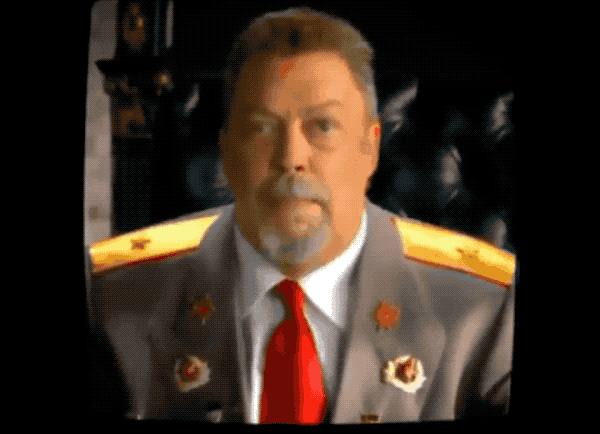 an animated GIF of Tim Curry as a Soviet Leader in the video game Red Alert 3, he can be seen here dressed in uniform, trying not to laugh while in character, as he breaks out while looking upwards to say, "SPACE!"