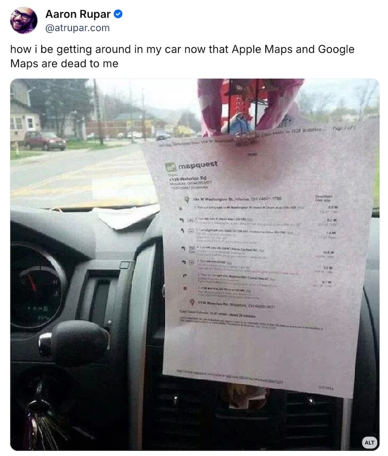 Aaron Rupar post on Bluesky: "how i be getting around in my car now that Apple Maps and Google Maps are dead to me," followed by a photo of a printed out paper Mapquest directions mounted to rearview mirror in a car.