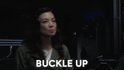 an animated GIF of a character on Agents of Shield walking towards the camera and saying, "buckle up"
