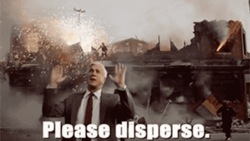 an animated GIF of Leslie Neilsen in Naked Gun, stood in front of an exploding building, saying, "nothing to see here, please disperse."