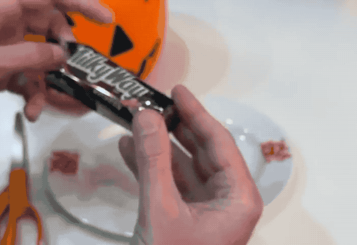 A candy-like bar which when unwrapped from its wrapper shows a mini-display that's running Doom.