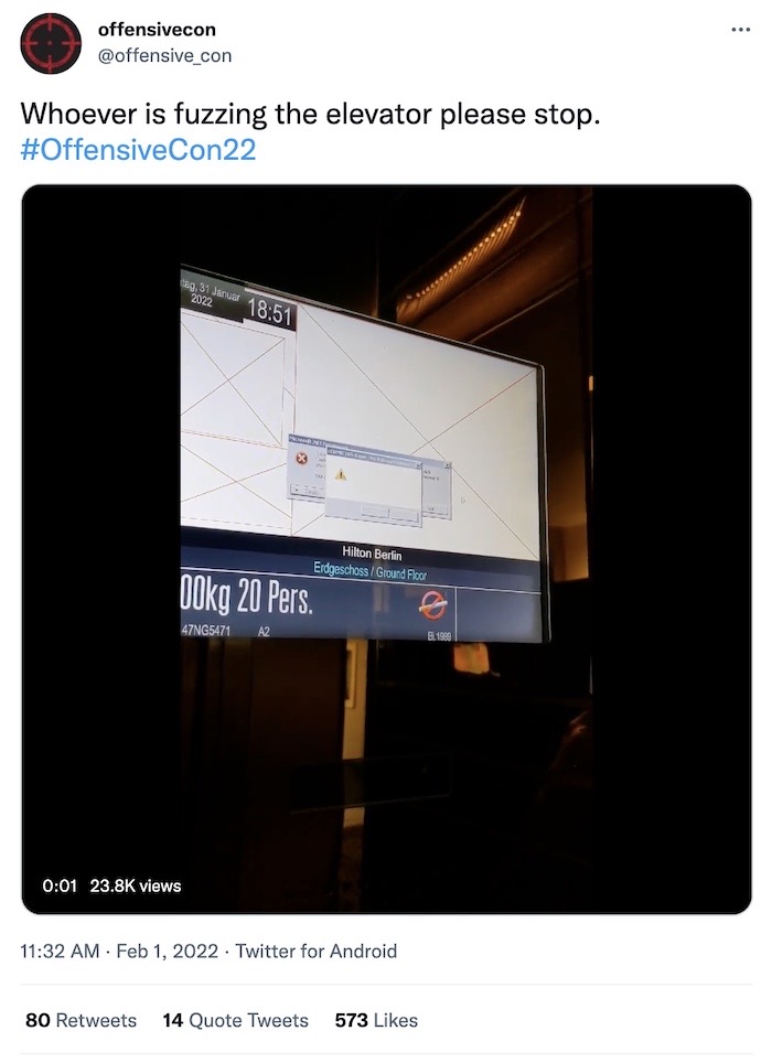 Screenshot of a screen in an elevator with an error message, plus this OffensiveCon22 tweet: "Whoever is fuzzing the elevator please stop."