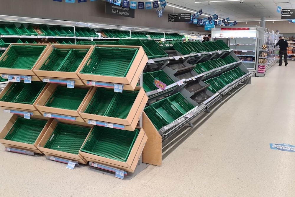 A photo of a Co-op store with shelves largely empty from fresh produce.