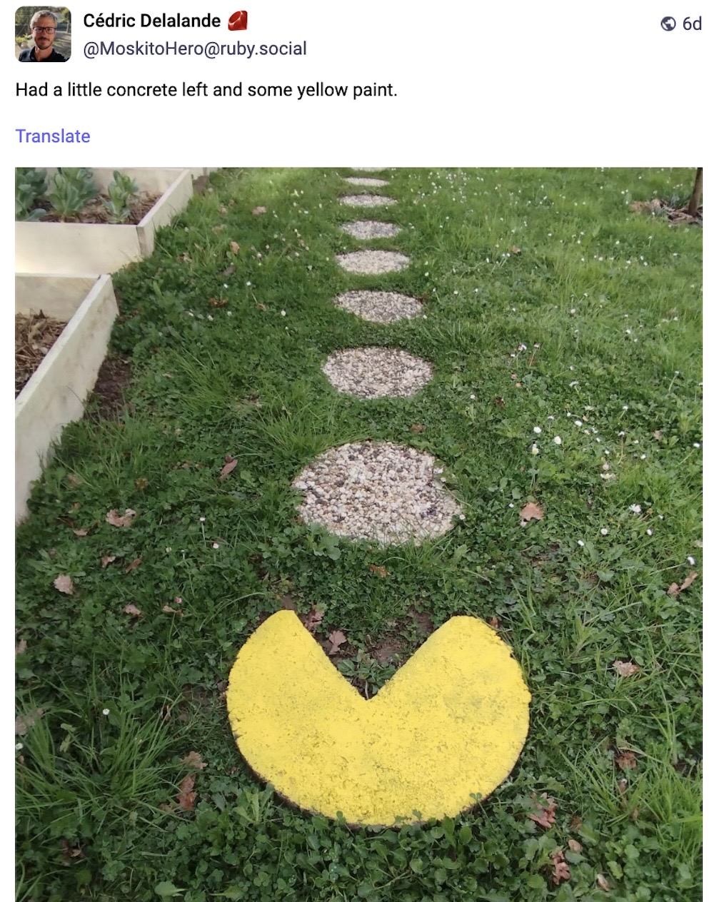 Mastodon post by Cedric Delalande: "Had a little concrete left and some yellow paint," followed by an image of a garden path with several circular concrete steps, followed by one that's painted yellow and looks like Pac-Man.