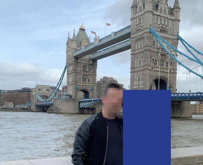 A redacted photo of "Jack," the alleged Russian supplier of a notorious malware, who is seen stood next to Tower Bridge in London in an undated photo.